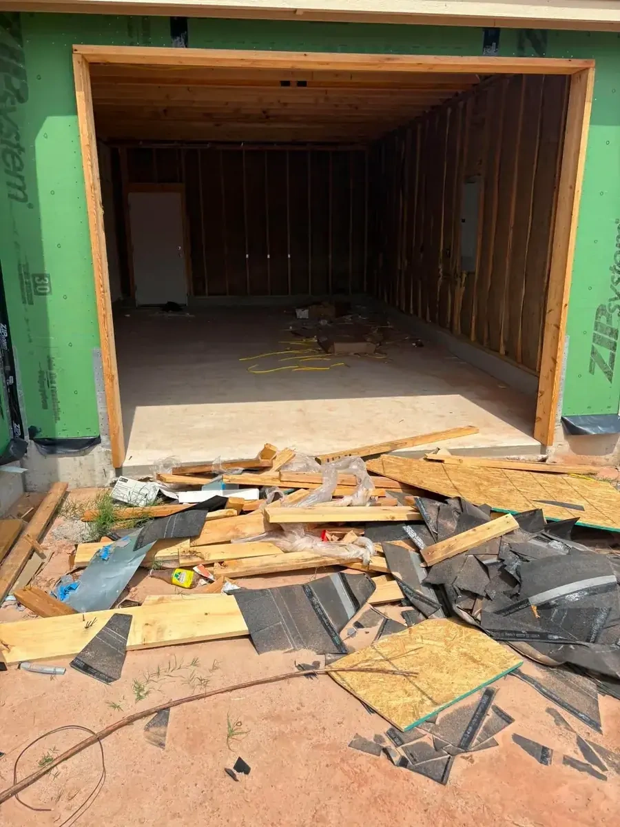 Construction site roofing and building debris before removal by Trash Wrangler Junk Removal